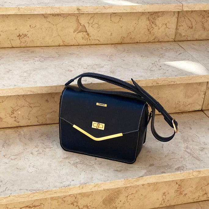 תיק עור כחול כהה אלגנט לתליה על הכתף או בהצלבה בתיפורי שמנת מודגשים